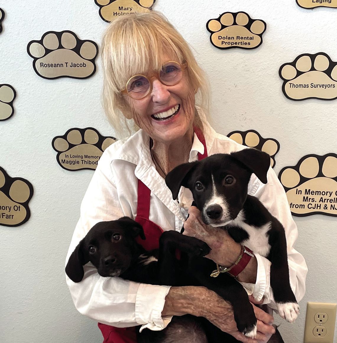 Lizzie Rosson, PAOC volunteer, holds two “ready to hire” pups. (Contributed Photo)
