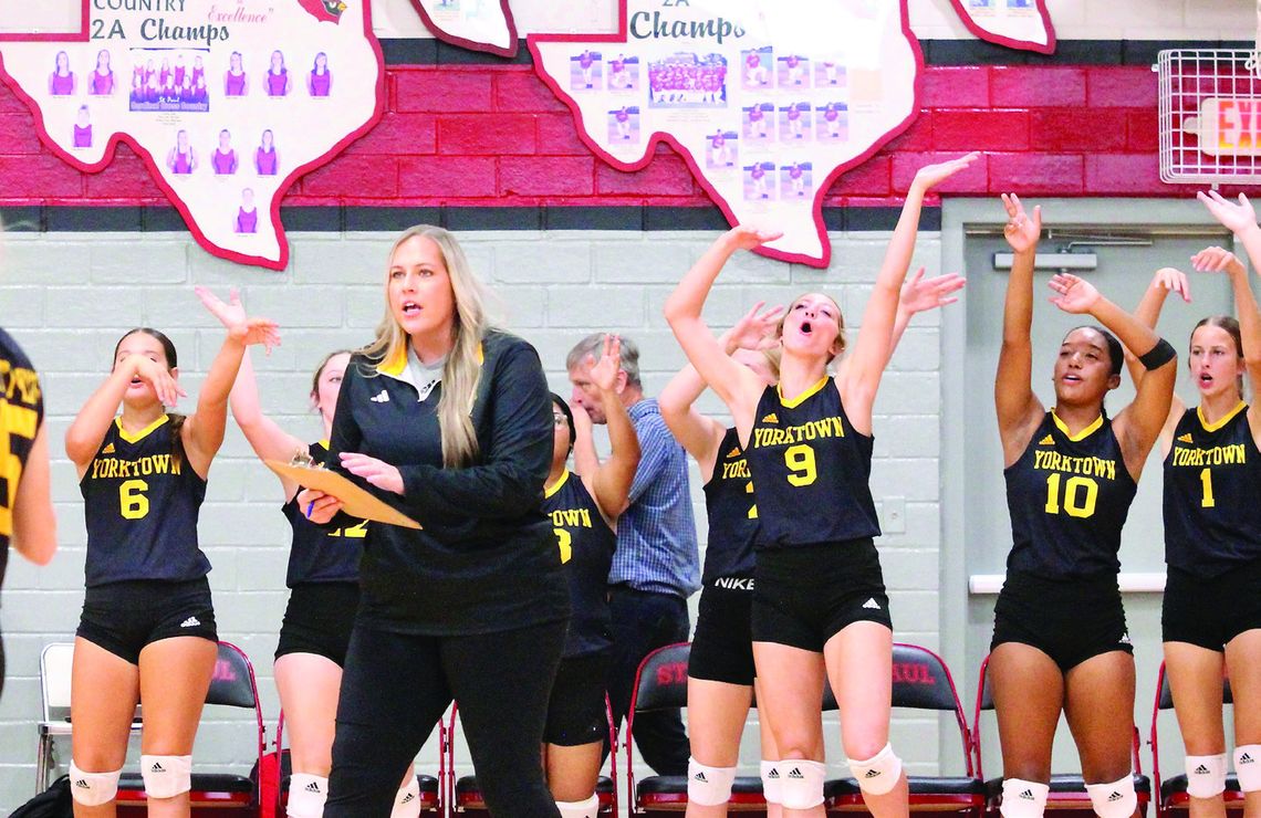 Coach Henkes instructs her team while the bench cheers over a good play. PHOTOS BY DEIRDRE ALEXANDER