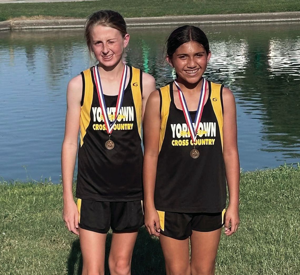 Yorktown 7th grade girls Camille Person (left) and Meigh Naranjo (right) medaled in 6th and 7th place respectively at the District 31-2A JH Cross Country Meet. CONTRIBUTED PHOTOS