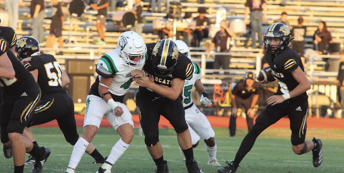 Trent Foerster and Ryan Knostman block their opponents while Brody Metting looks to dart up the field. PHOTO BY DEIRDRE ALEXANDER