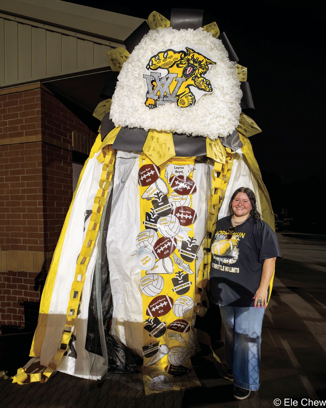 Emmalee Alatorre, the Lion’s Club September Teacher of the Month, shows off the Giant Mum her floral design students created for homecoming. During transport Friday, the ribbons were damaged, so the length was reduced. PHOTO BY ELE CHEW